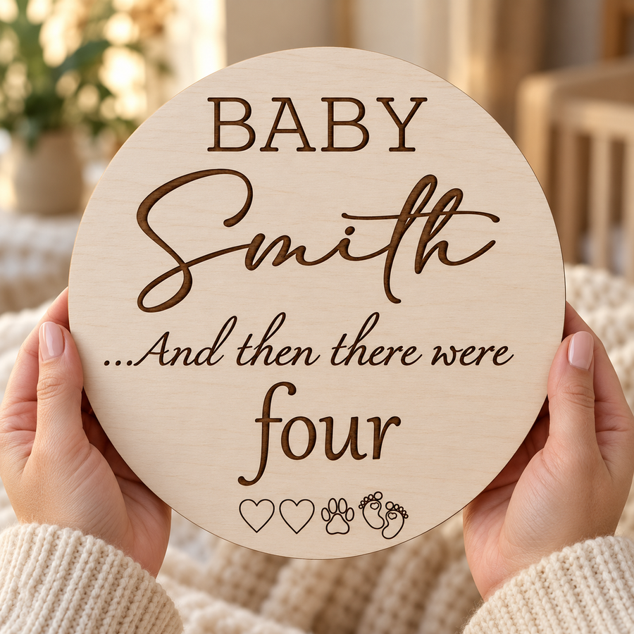 And Then There Were four wooden family announcement sign held in hands with hearts, paw and baby footprints