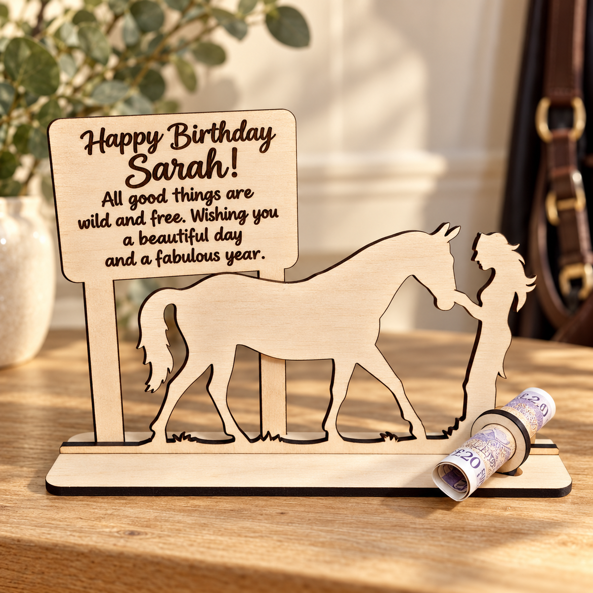 Personalised wooden horse money holder for Sarah, with a female silhouette, dark engraved birthday message and rolled £20 banknote