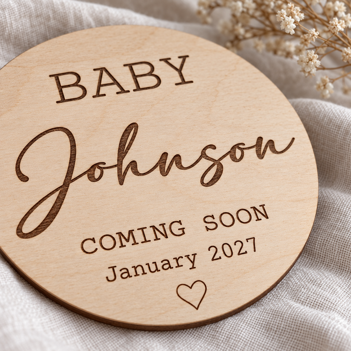 Close-up of dark engraved lettering and natural birch wood grain