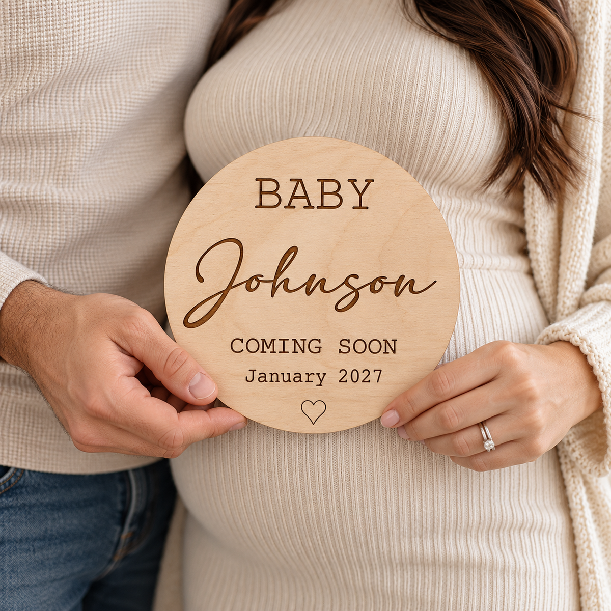 Couple holding a personalised Coming Soon pregnancy photo prop