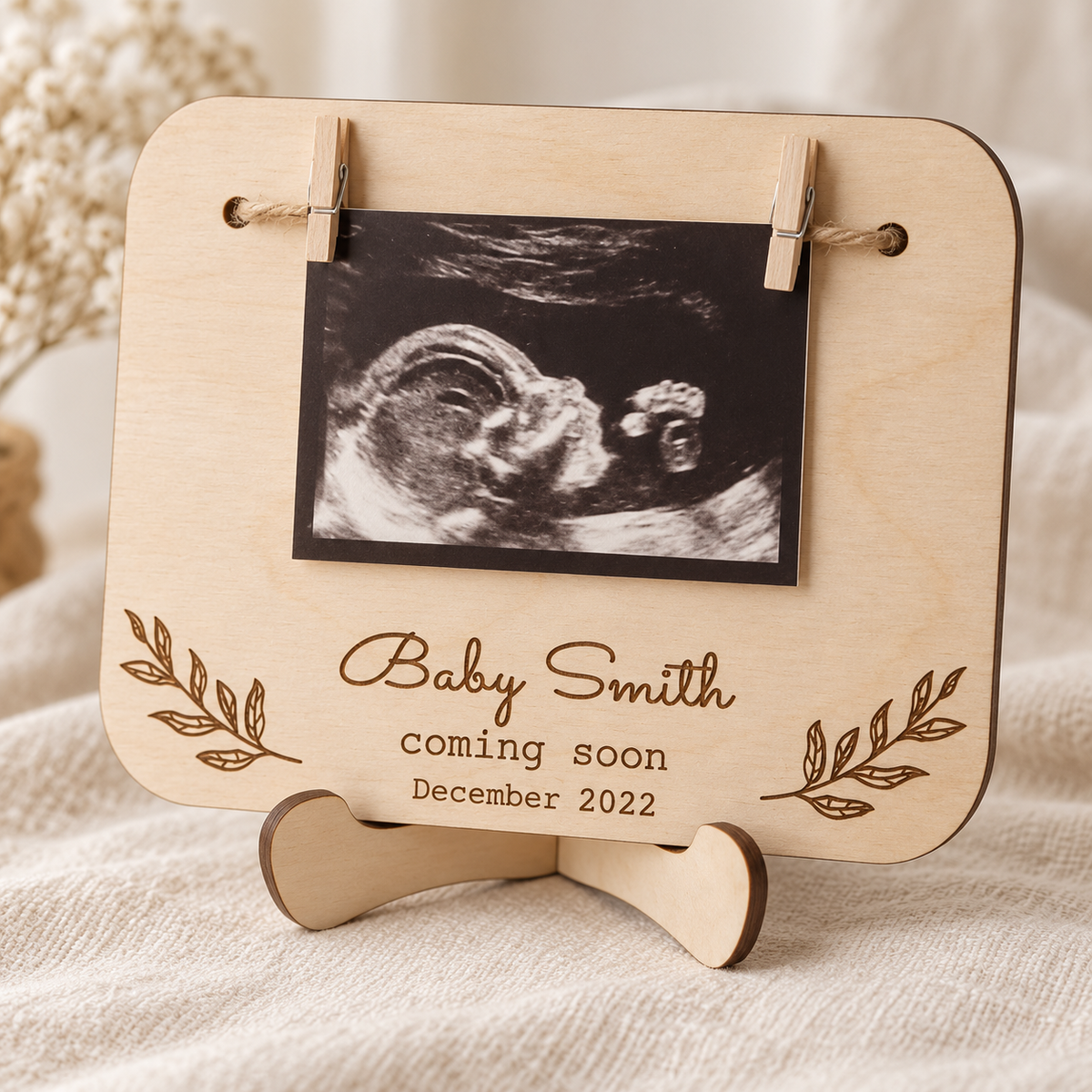 Close-up of the wooden baby scan sign, pegs and display stand