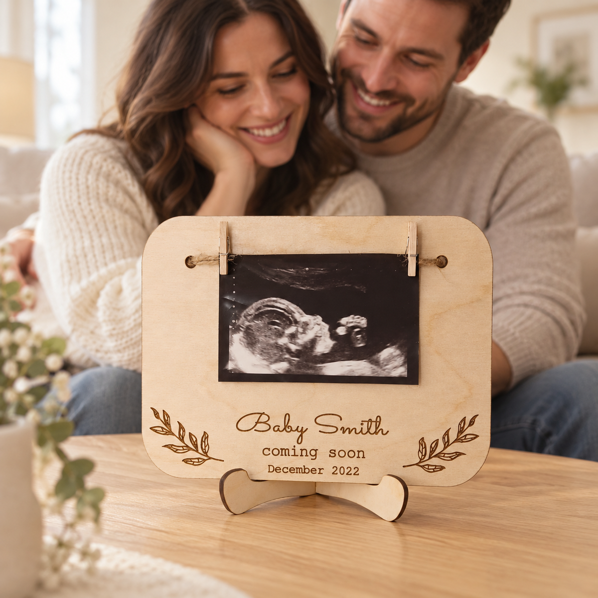 Personalised baby scan sign displayed in front of expectant parents