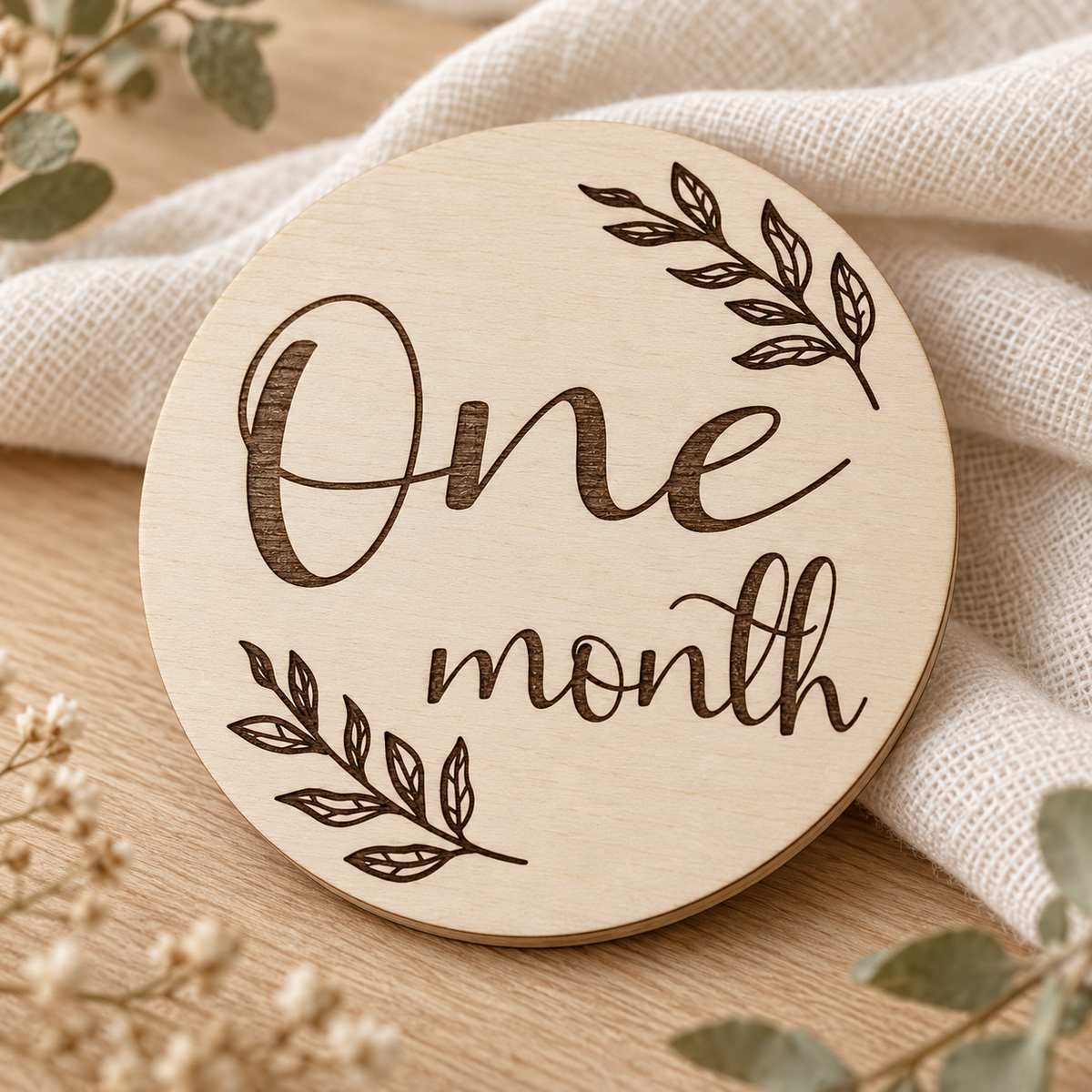 Close-up of dark laser engraving and birch grain on a One month card