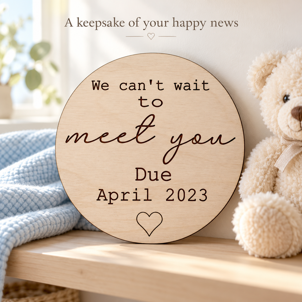 Engraved wooden pregnancy keepsake plaque displayed on a nursery shelf beside a cream teddy bear.
