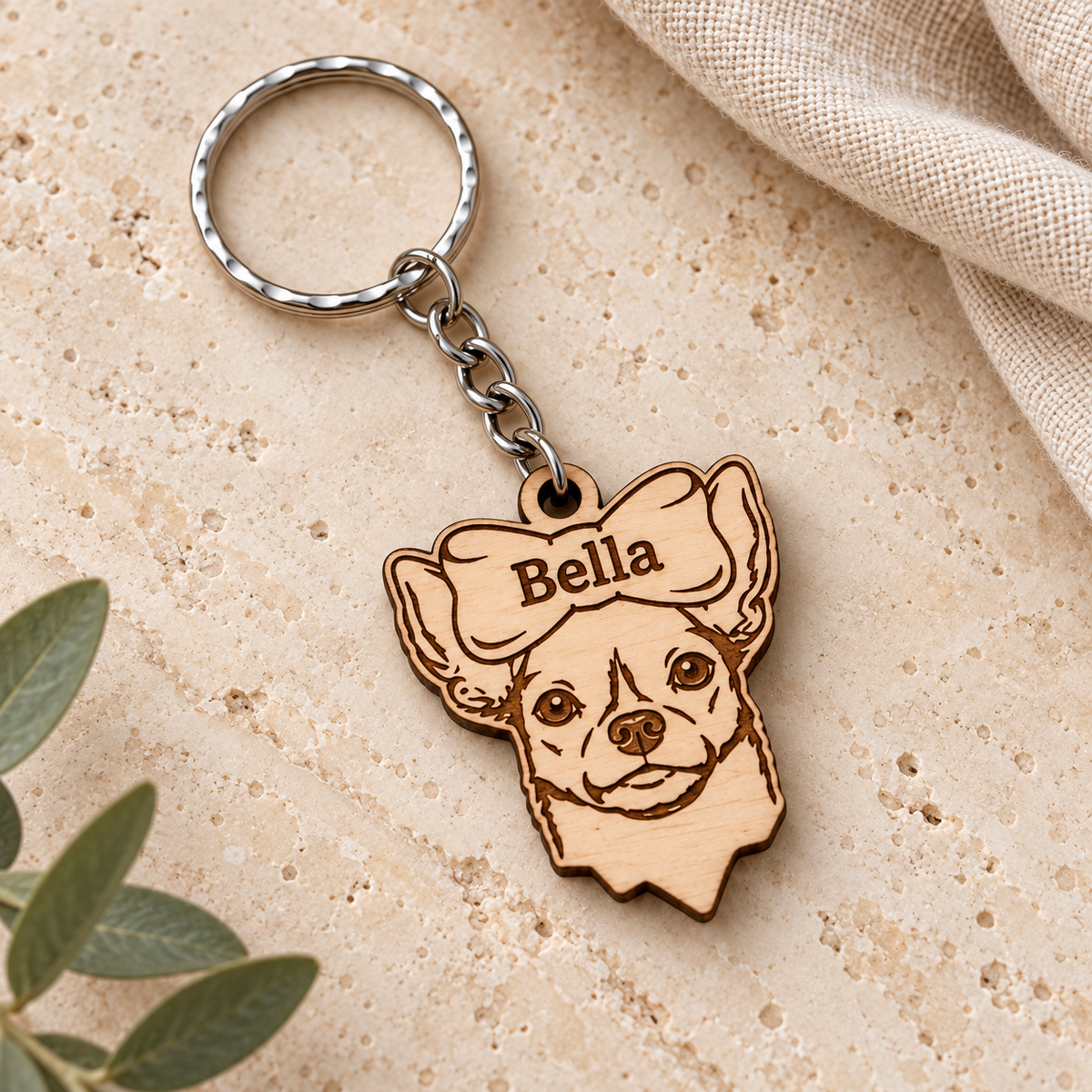 Personalised Bella wooden Chihuahua keyring with name bow above the face, silver chain and split ring on cream stone