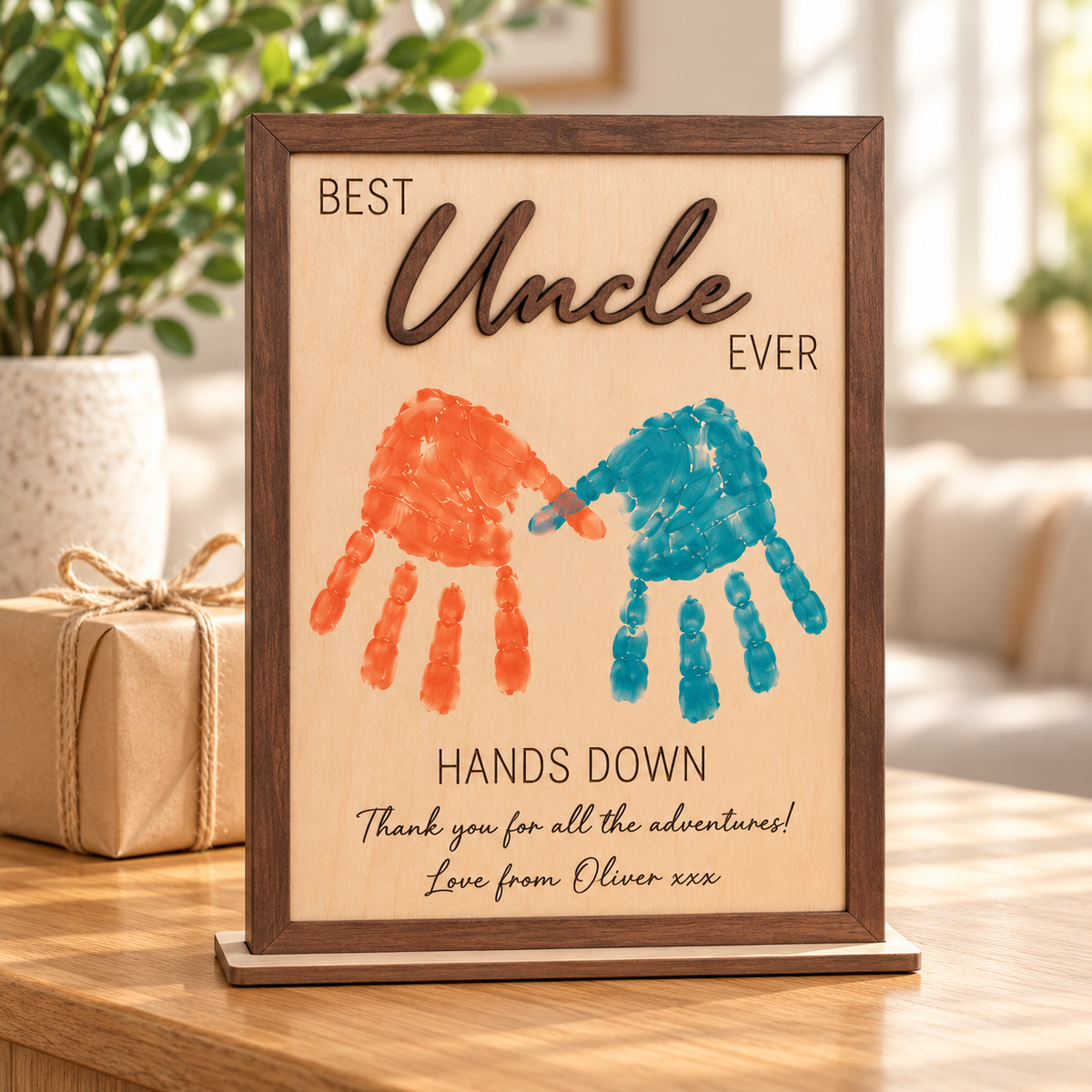Brown Best Uncle Ever handprint frame with orange and teal prints and an engraved message from Oliver.