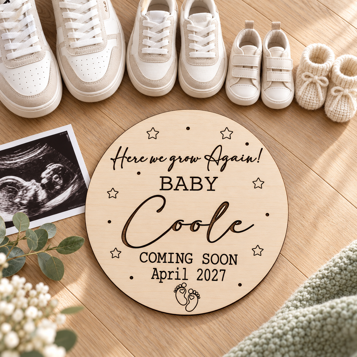 Growing family pregnancy reveal with engraved wooden plaque and adult, toddler and baby shoes