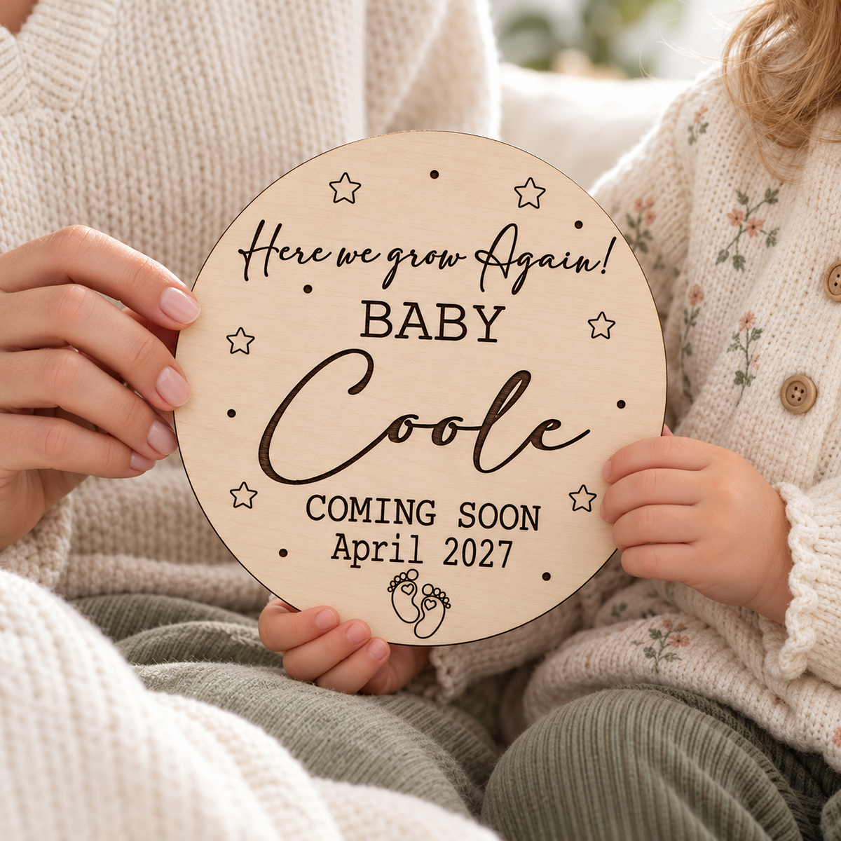 Mother and child holding a personalised Here We Grow Again pregnancy announcement plaque