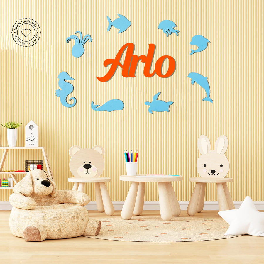 Personalised wooden name sign for kids featuring ocean-themed sea animals in blue and orange, perfect nursery or playroom wall decor.