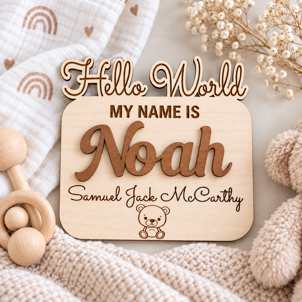 Natural birch newborn name sign with Noah in warm Brown raised lettering and Samuel Jack McCarthy engraved below.