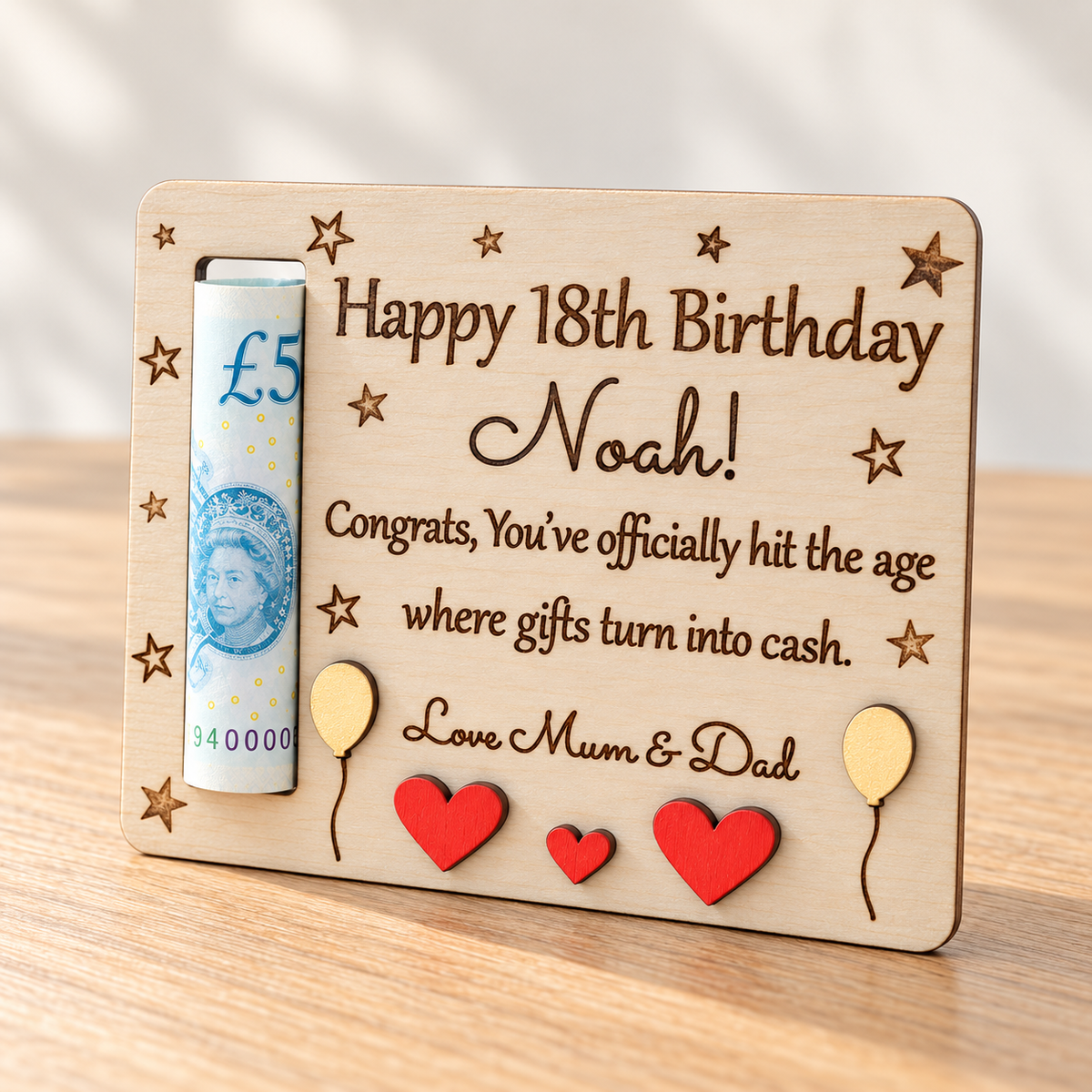 Personalised wooden money holder for Noah's 18th birthday with an engraved cash gift message and a rolled £5 banknote