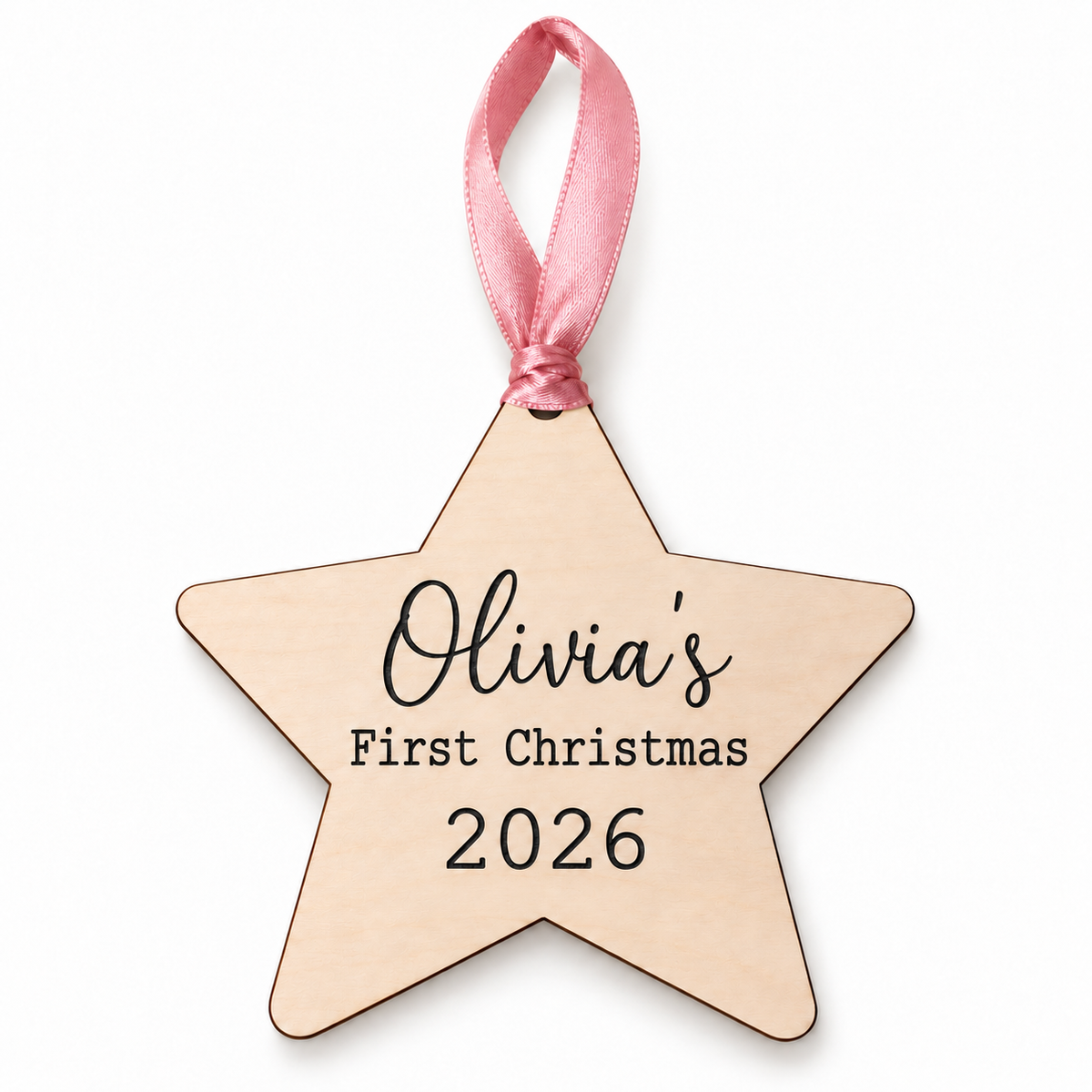 Olivia's first Christmas wooden star with black engraved name and 2026, pink ribbon, on a white background