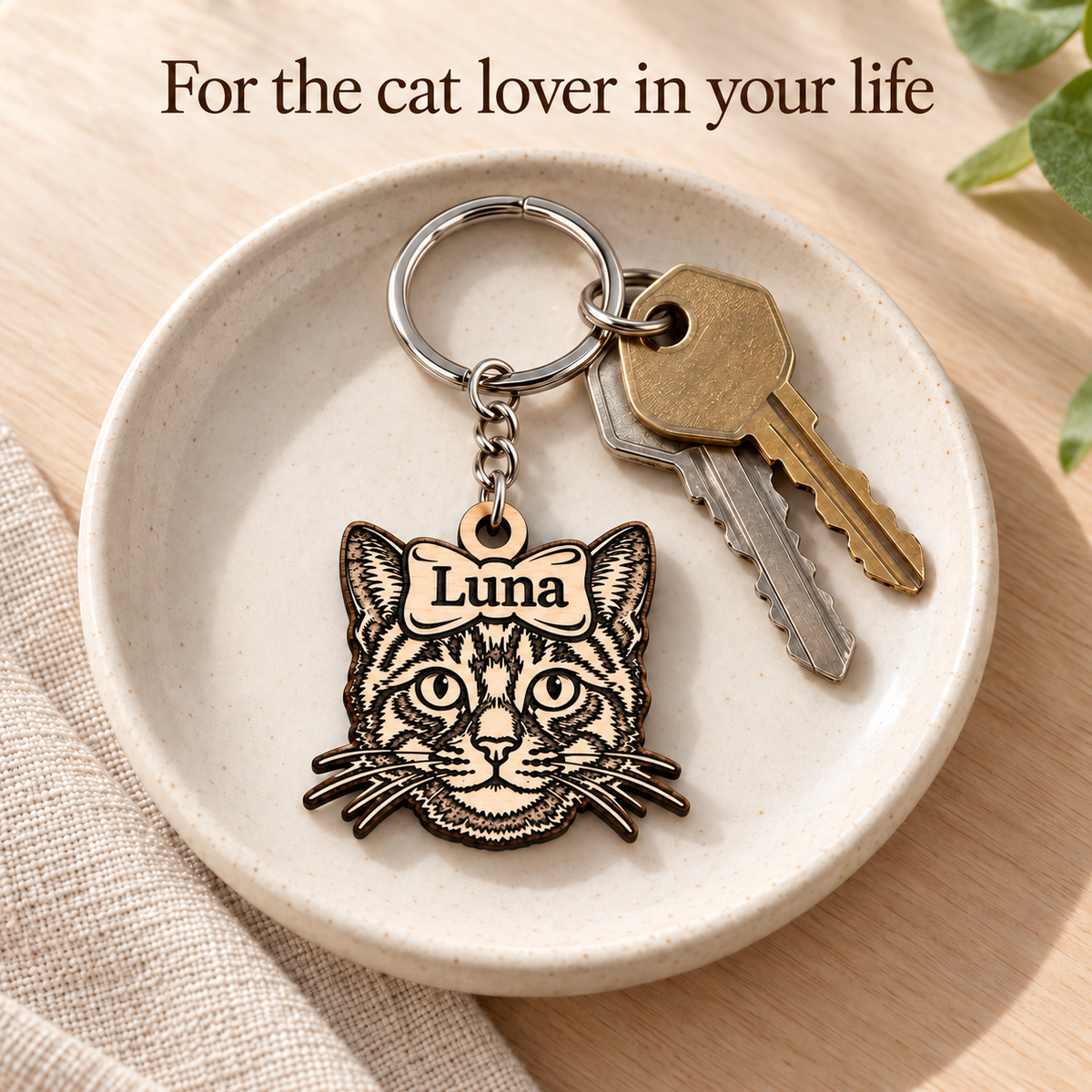 Luna personalised cat keyring and keys in a ceramic dish, a gift for a cat lover.