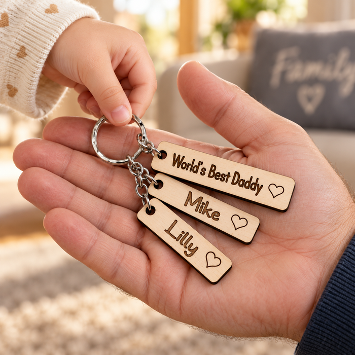 Child giving Dad a personalised World's Best Daddy wooden keyring with Mike and Lilly name charms.