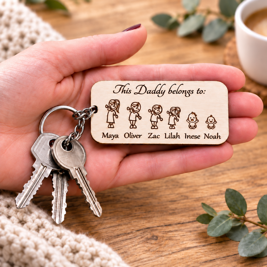 Personalised This Daddy belongs to wooden keyring with children's names, held in a hand with keys