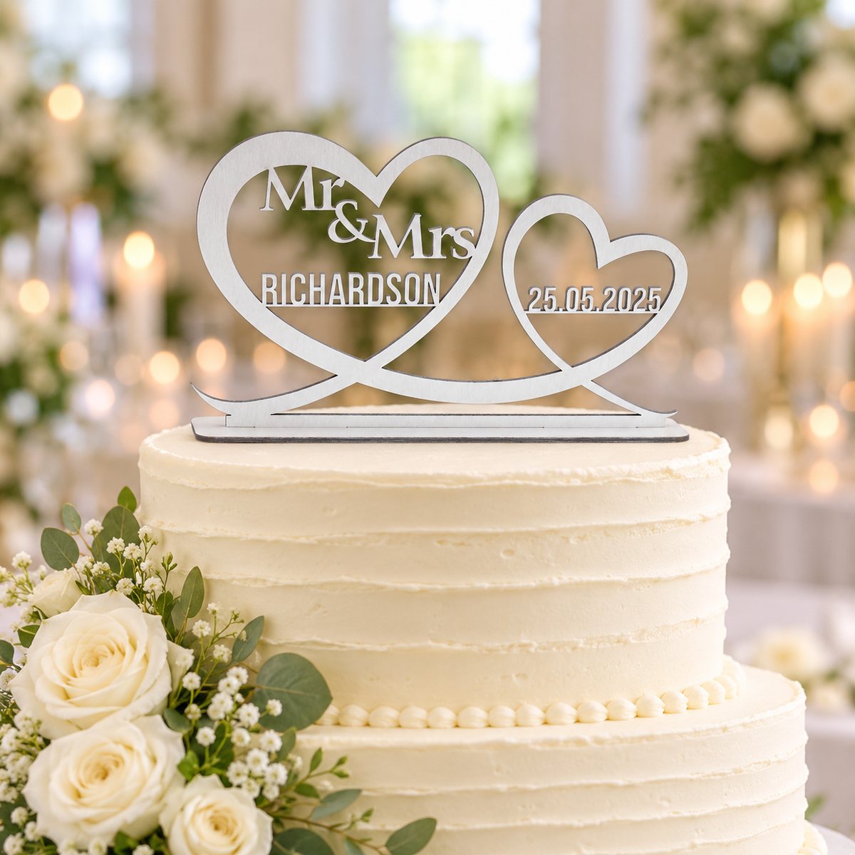 Silver personalised Mr and Mrs double heart wedding cake topper with surname and date on its freestanding base