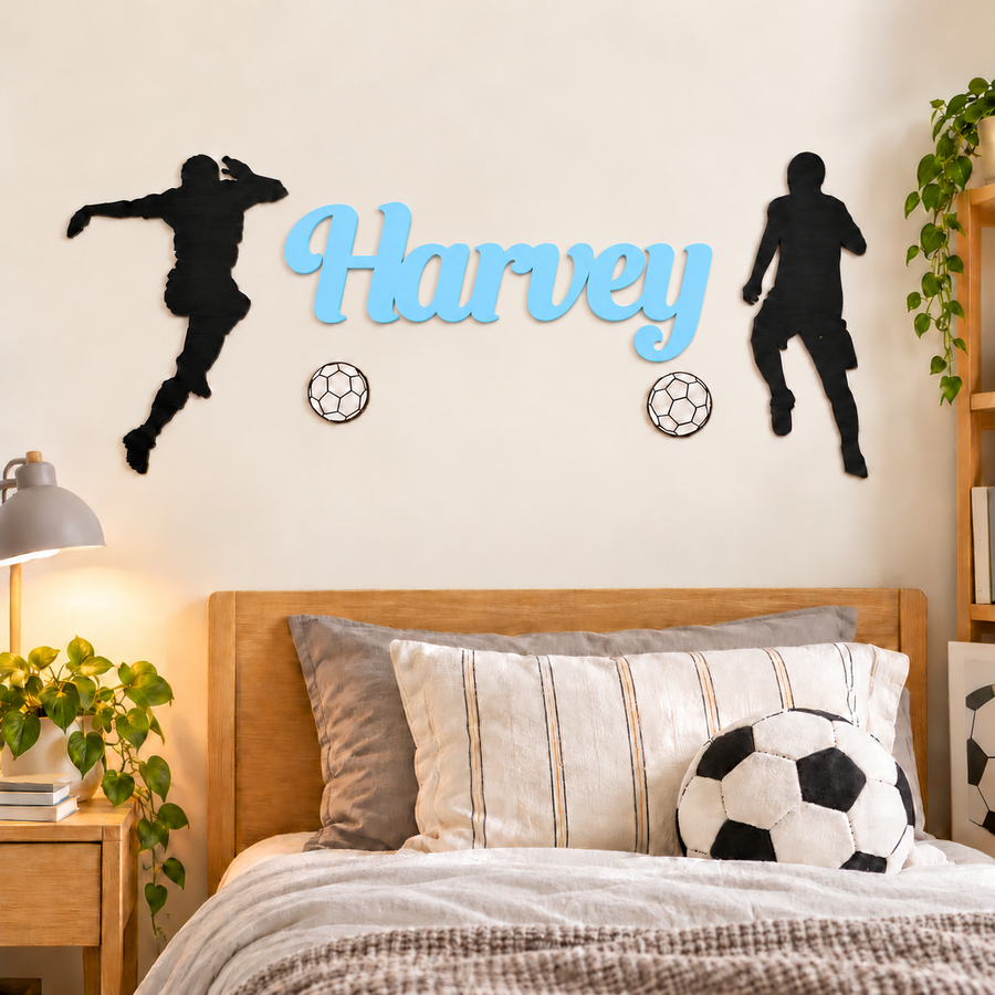 Pastel Blue Harvey wooden name sign with two black football players and two white footballs above a child's bed.