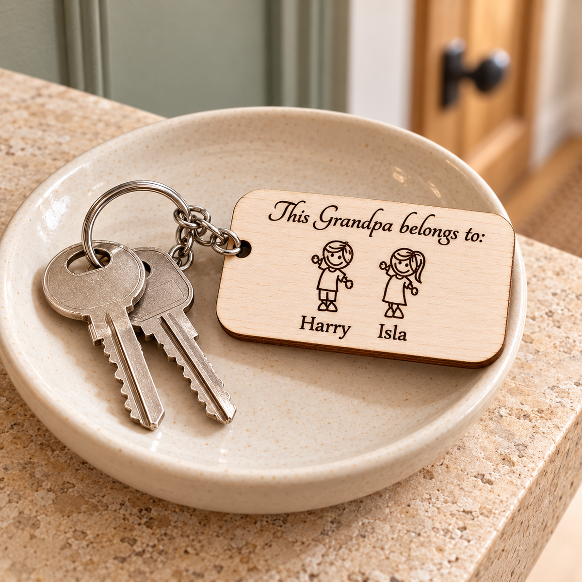 This Grandpa belongs to wooden keyring with two grandchildren, Harry and Isla, attached to house keys in an ivory ceramic dish