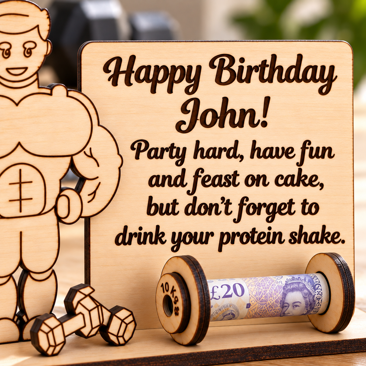 Close-up of personalised birthday message engraved on the wooden gym money holder