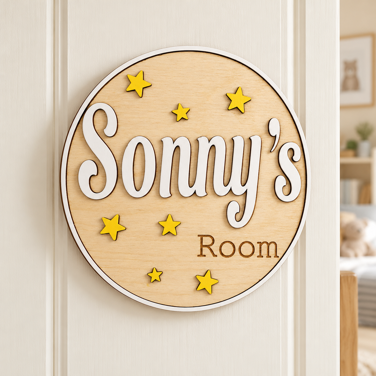 Personalised wooden bedroom door sign reading Sonny’s Room, with a white raised name and yellow stars on an ivory door