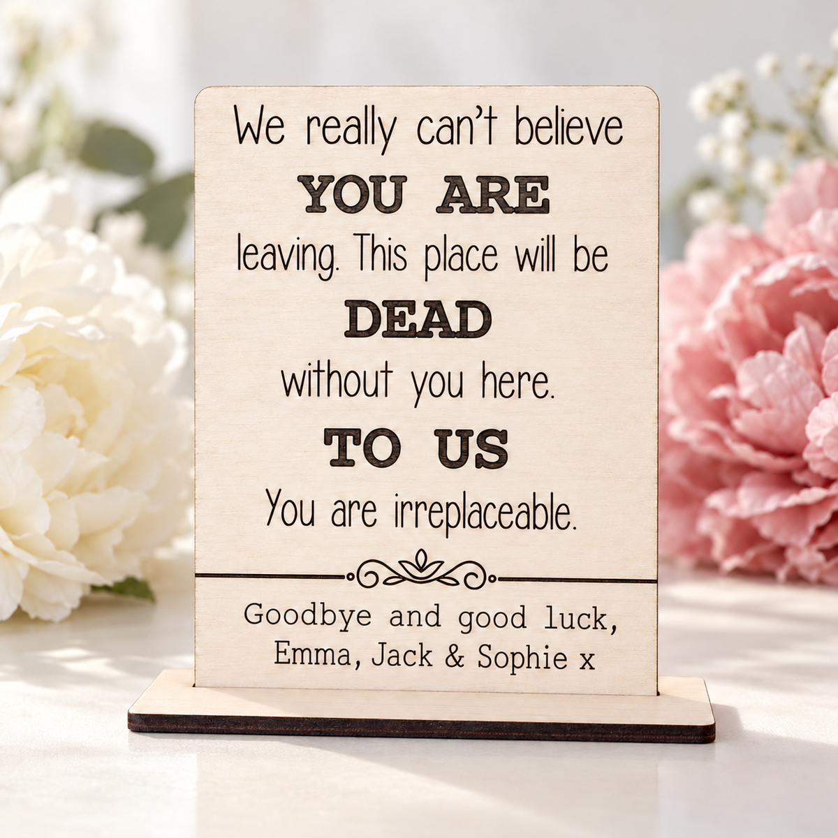 Personalised leaving card in a wooden stand with dark engraving and flowers