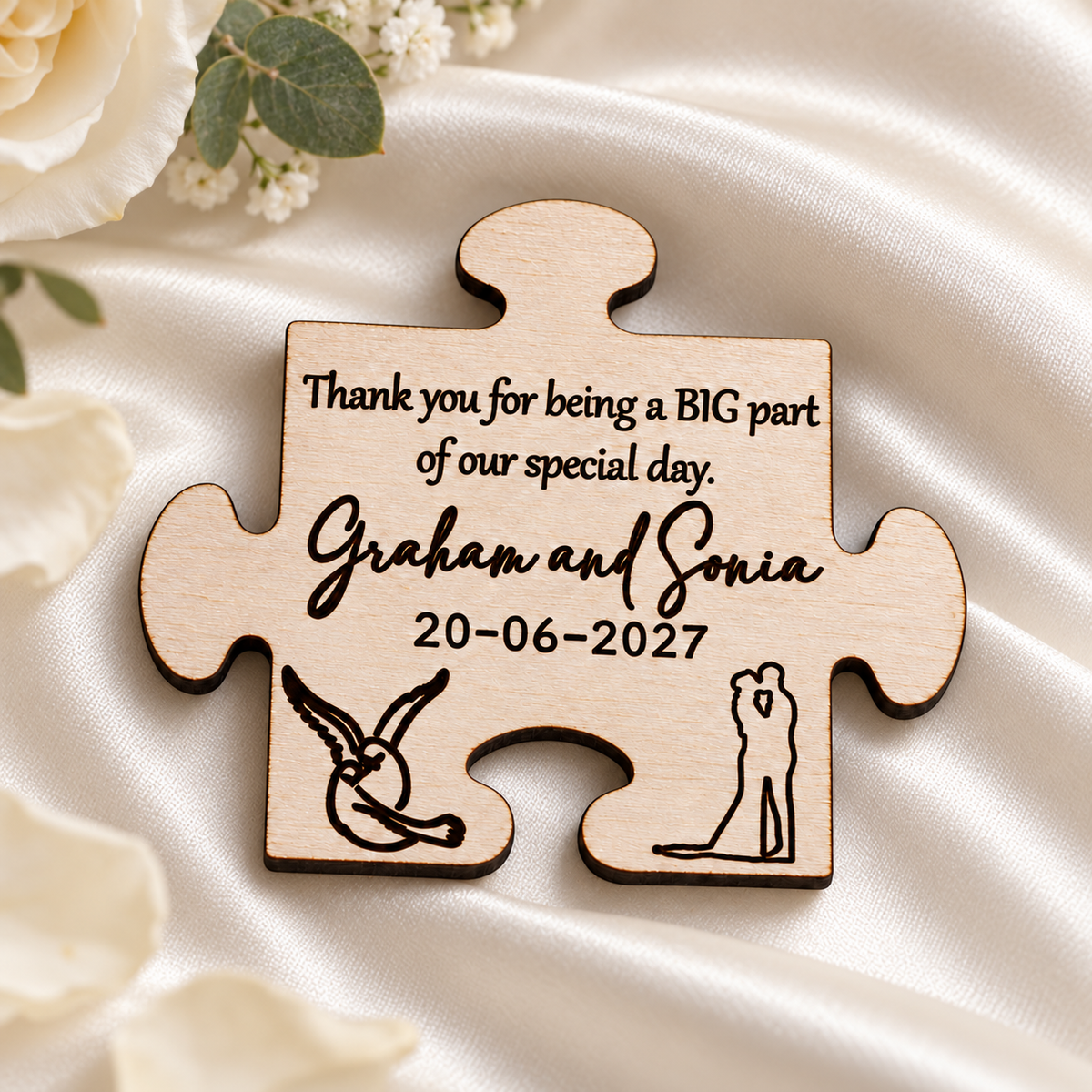 Personalised wooden puzzle piece wedding favour magnet with engraved names and wedding date on ivory satin.