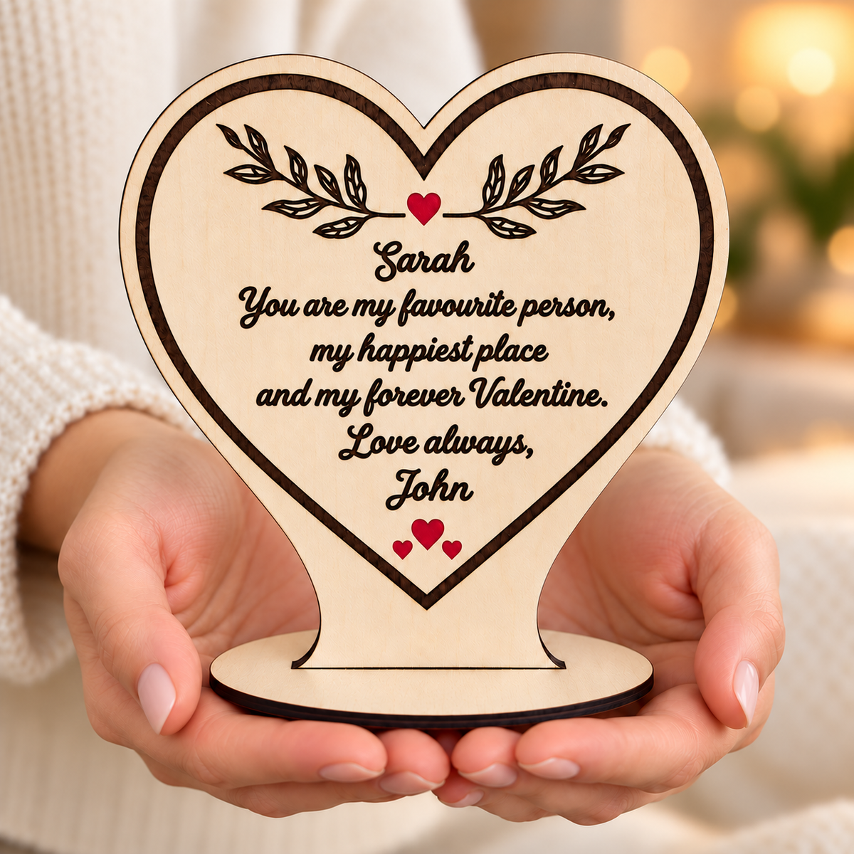 Personalised wooden heart plaque held in hands with a romantic forever Valentine message