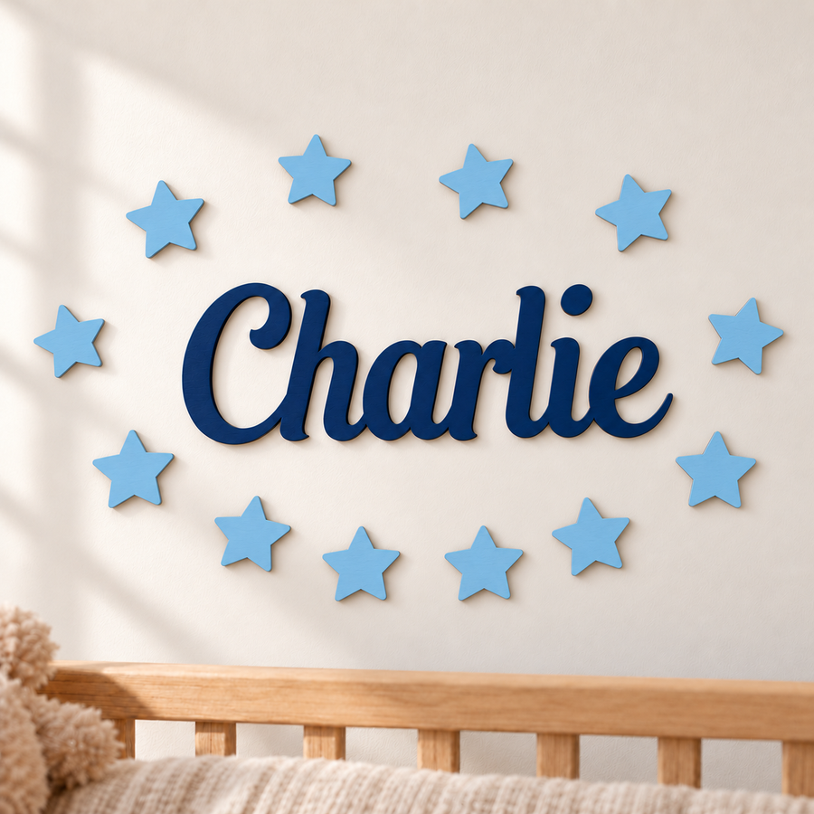 Navy blue personalised wooden name Charlie with 12 pastel blue stars on a nursery wall