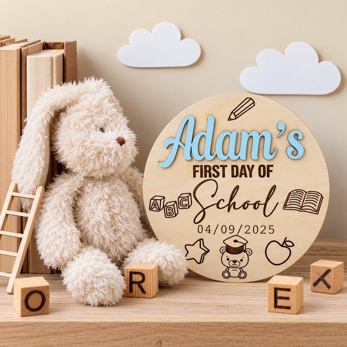 Wooden first day of school plaque with pastel blue raised name beside a rabbit and books