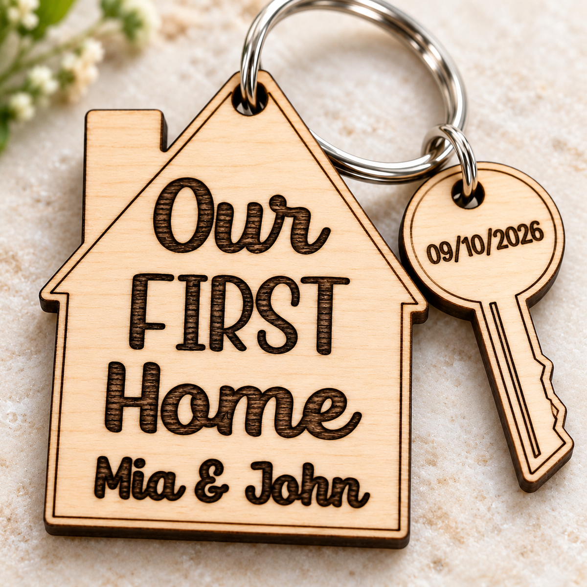 Close-up of the dark engraved Our First Home wording, personalised names and natural wood grain.