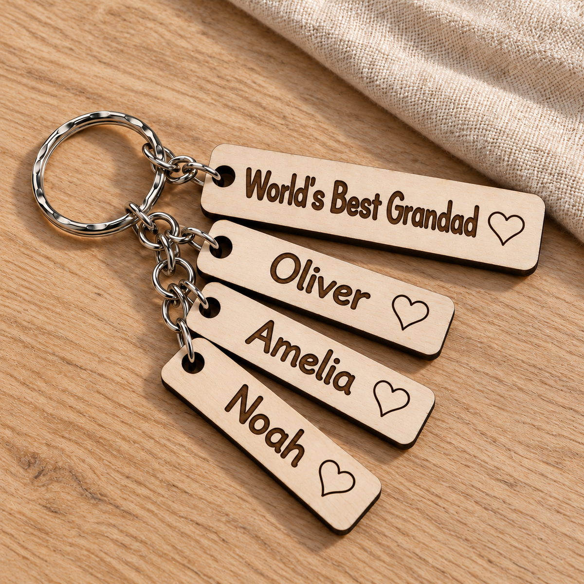World's Best Grandad engraved birch plywood keyring with Oliver, Amelia and Noah name charms.