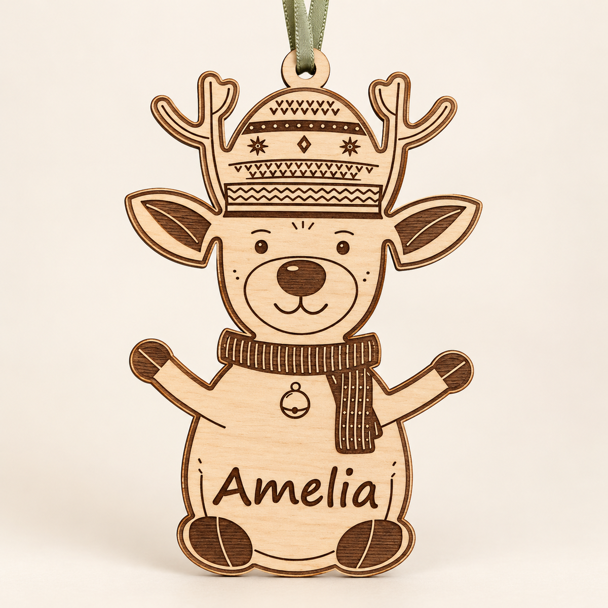 Full front view of the personalised Amelia reindeer Christmas bauble with a sage green ribbon against an ivory background.