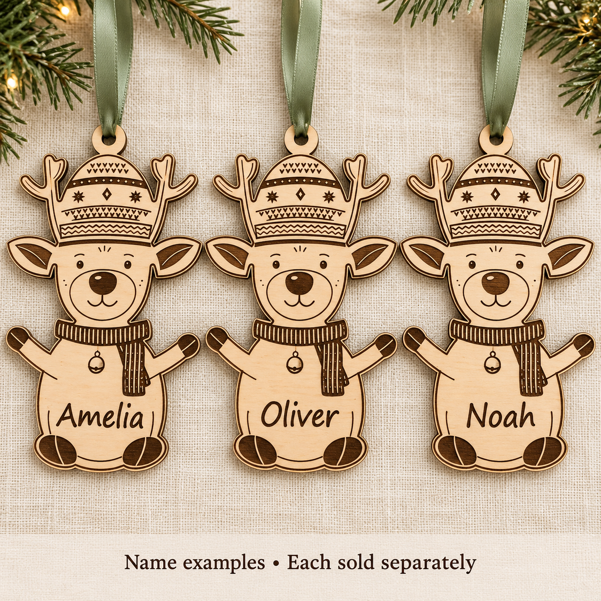 Wooden reindeer baubles engraved with Amelia, Oliver and Noah, showing name examples; each ornament is sold separately.