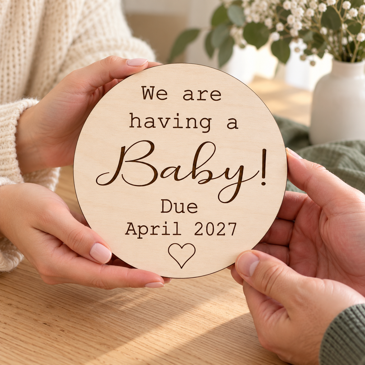 Personalised We are having a Baby sign being handed to a loved one for a pregnancy reveal