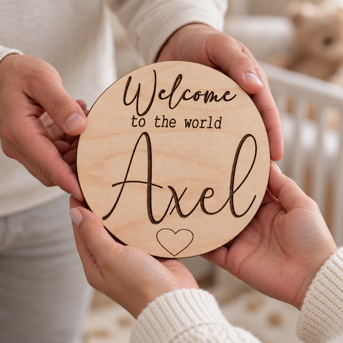 Personalised Welcome to the World wooden name plaque being passed between two adults as a newborn keepsake