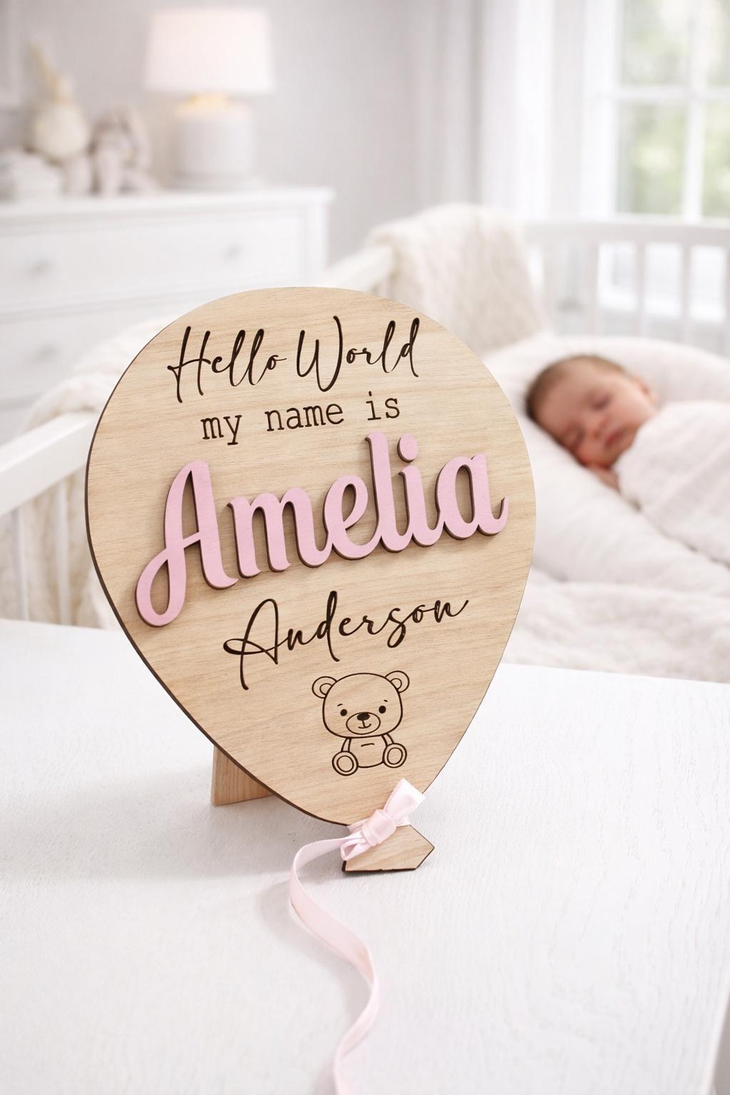 Original Amelia Anderson personalised wooden baby announcement balloon with Pastel Pink raised name and Pink ribbon in a bright nursery.