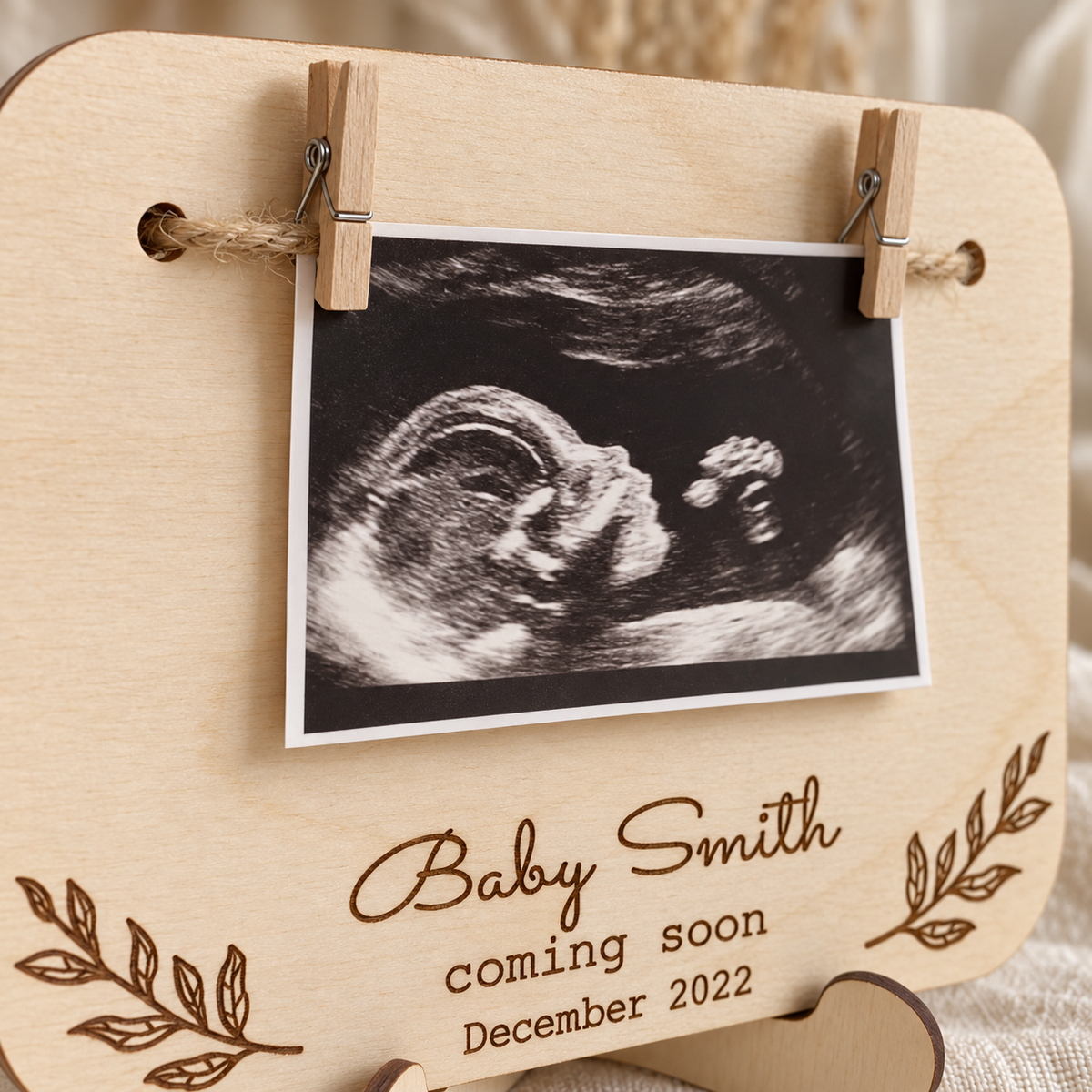 Wooden pegs and jute cord holding a printed ultrasound photo