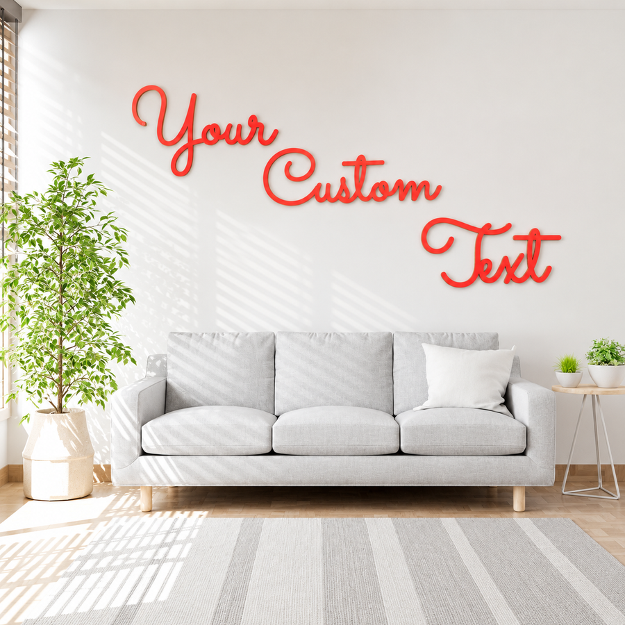 Coral red Your Custom Text wooden letters arranged diagonally above a grey sofa in a bright living room.