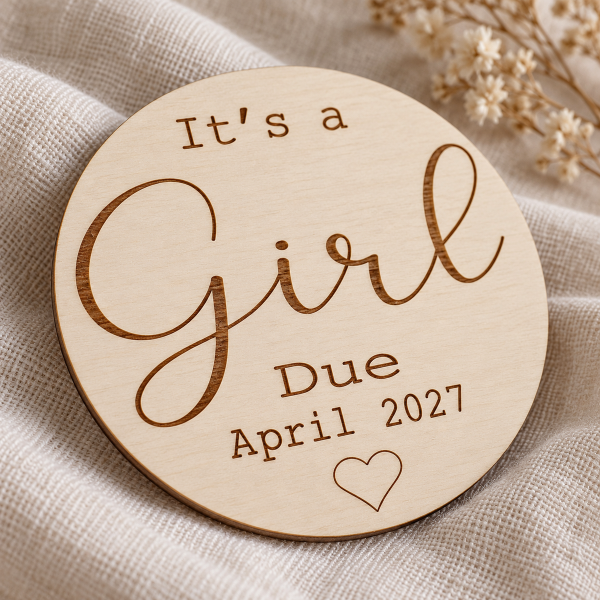 Close detail of recessed brown Girl lettering and due date engraved into natural birch plywood