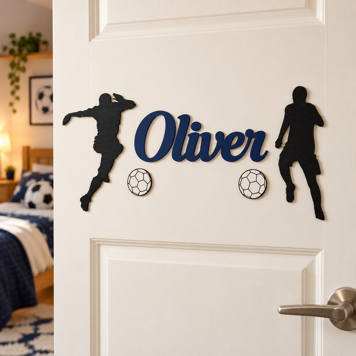 Navy Blue Oliver name with separate black footballer silhouettes and white football decorations on a bedroom door.