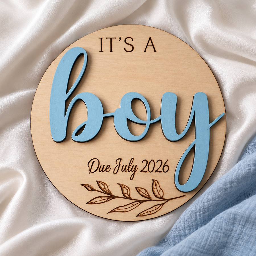 It's a Boy wooden gender reveal plaque on ivory satin, with Due July 2026 engraving