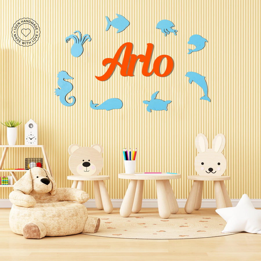 Personalised wooden name sign for kids featuring ocean-themed sea animals in blue and orange, perfect nursery or playroom wall decor.