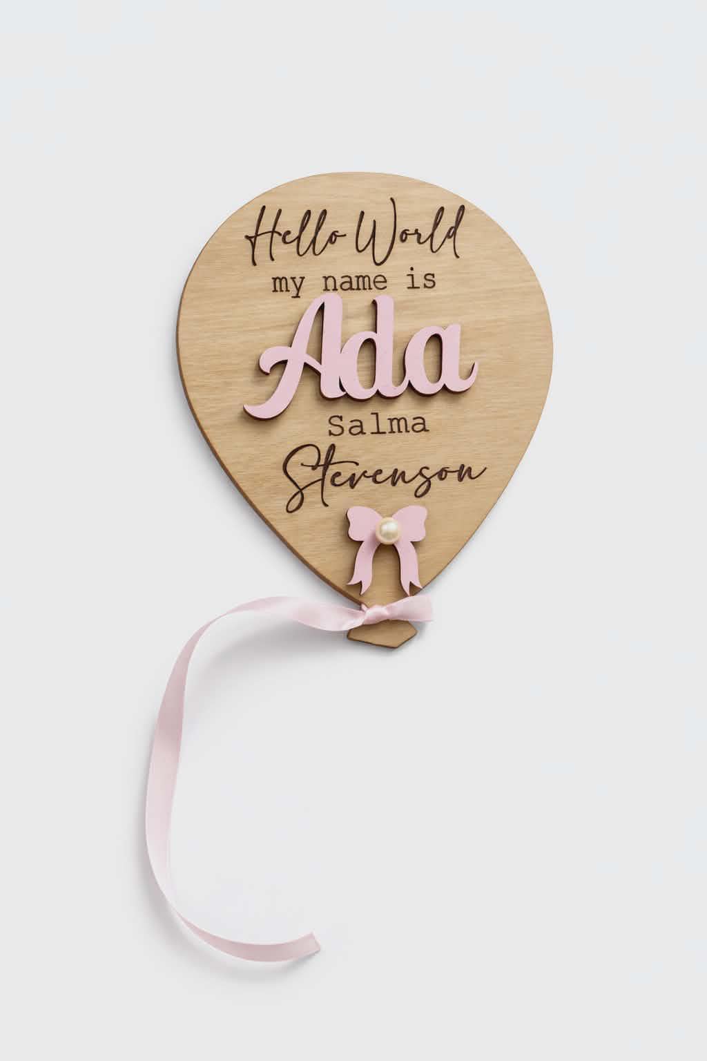 Personalised wooden balloon plaque with Hello World text, 3D name and pink ribbon.