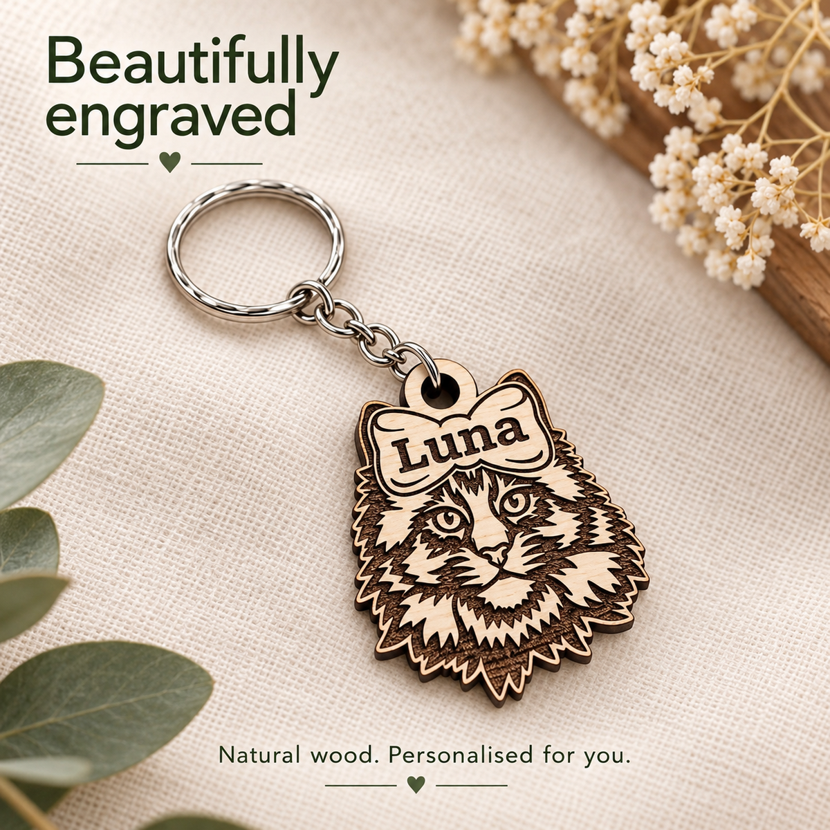 Close-up of dark Maine Coon cat engraving and a personalised name on natural birch wood