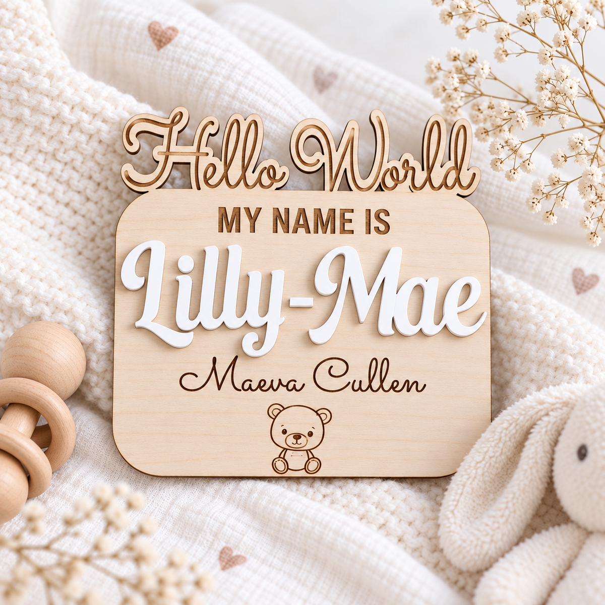 Cut-out Hello World wooden newborn name sign with Lilly-Mae in raised White lettering and Maeva Cullen engraved beneath.