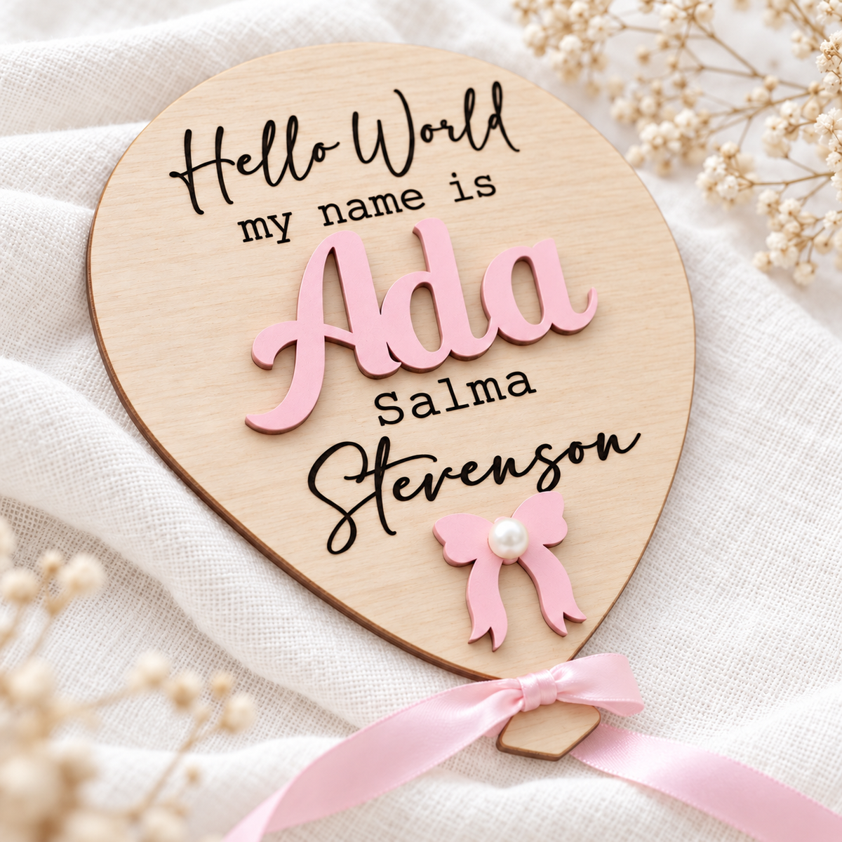 Raised pastel pink wooden Ada lettering and crisp engraved additional names on a birch balloon sign.