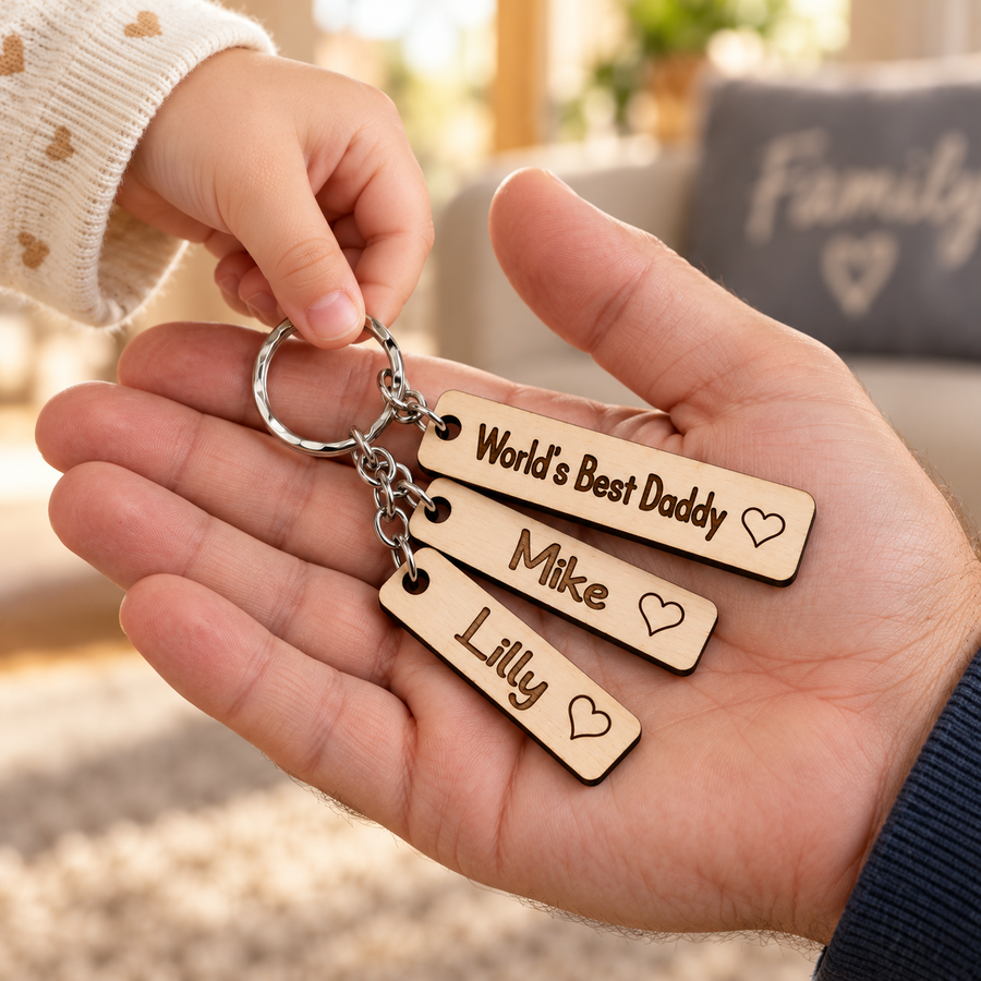 Child giving Dad a personalised World's Best Daddy wooden keyring with Mike and Lilly name charms.