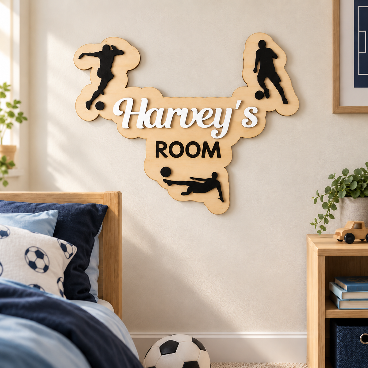 White Harvey’s ROOM wooden football name plaque displayed on a child's bedroom wall with three black player silhouettes.