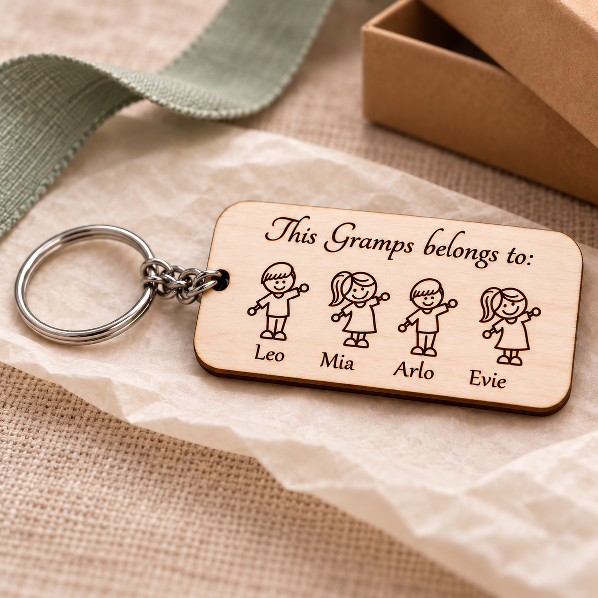 This Gramps belongs to personalised wooden keyring with four grandchildren, Leo, Mia, Arlo and Evie, styled as a gift