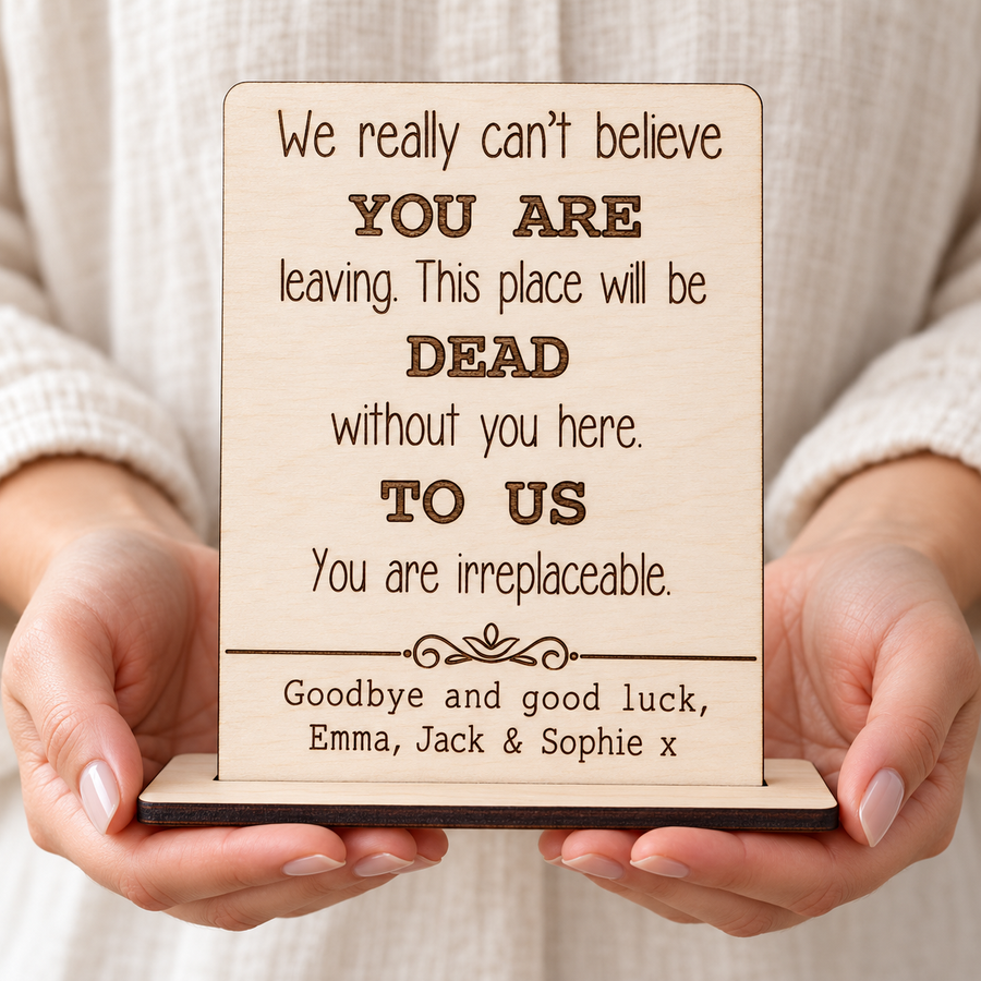 Personalised wooden leaving card held in hands, engraved with a farewell message